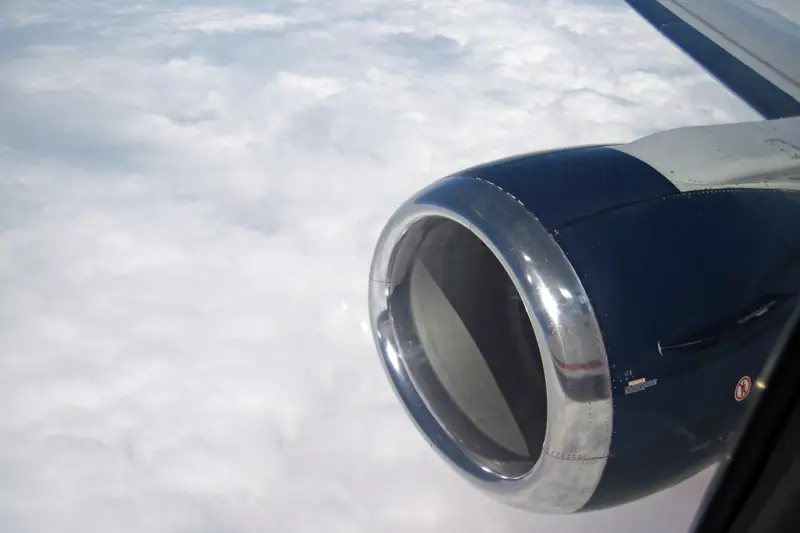 Jet engine above the clouds (illustrative)